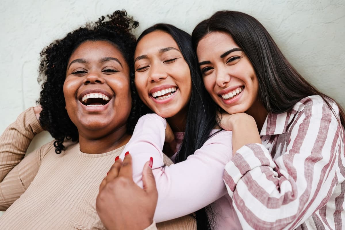 Three women laughing together